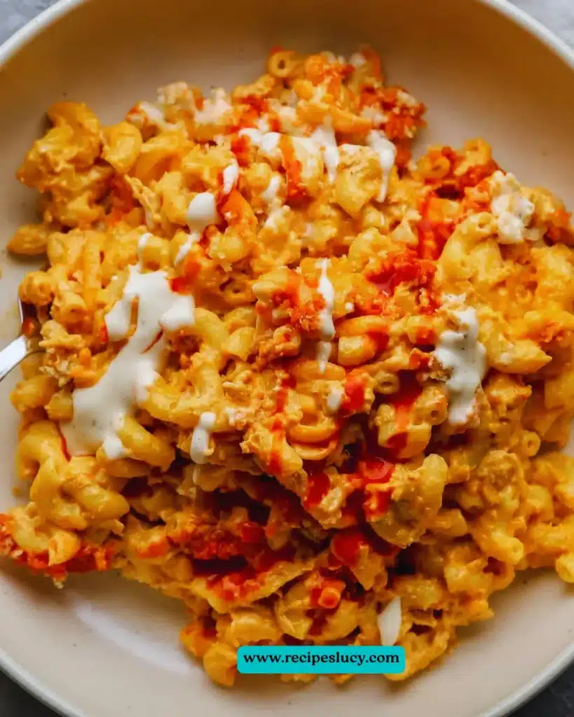 Vegan Buffalo Mac and Cheese in a bowl garnished with fresh herbs