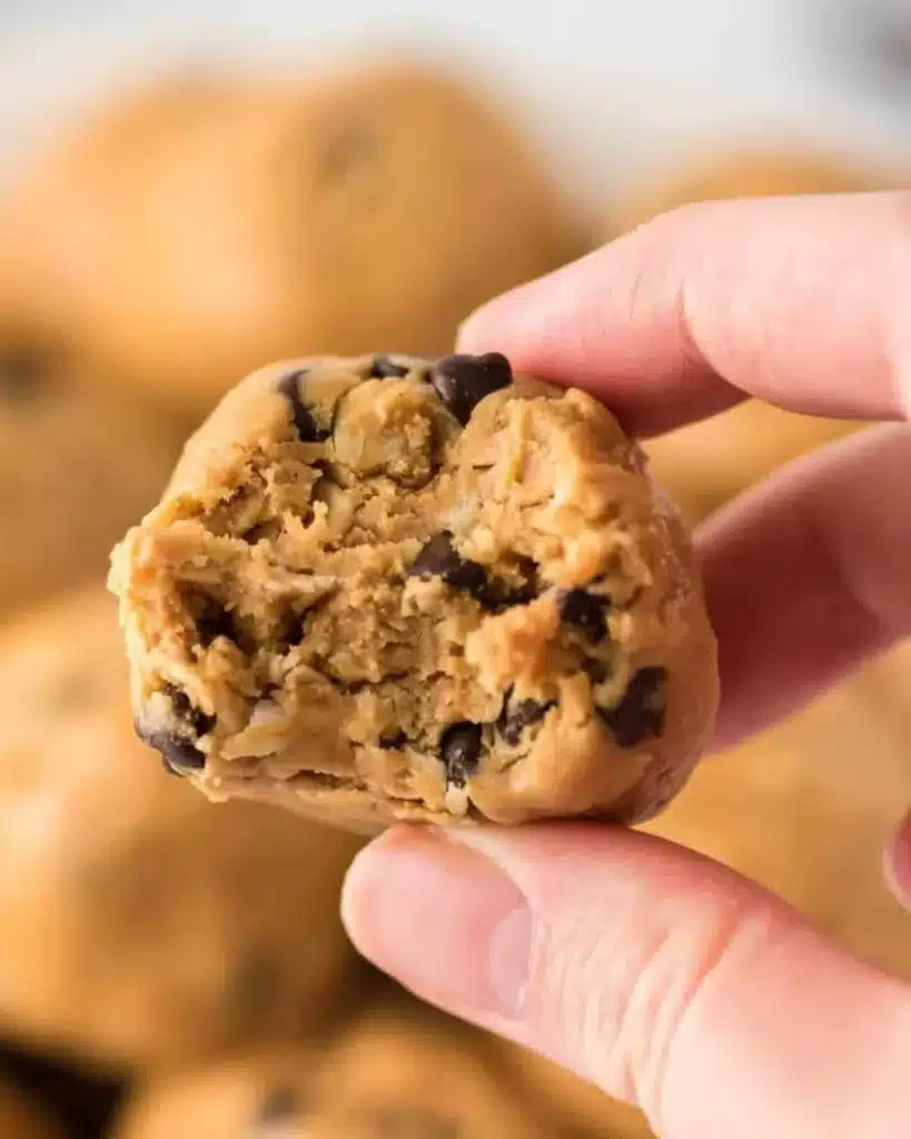 A variety of homemade energy balls on a rustic wooden table.