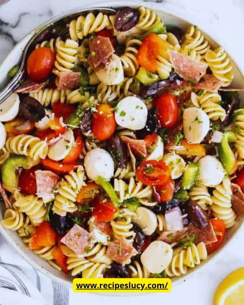 Colorful Italian pasta salad with vegetables and dressing in a bowl