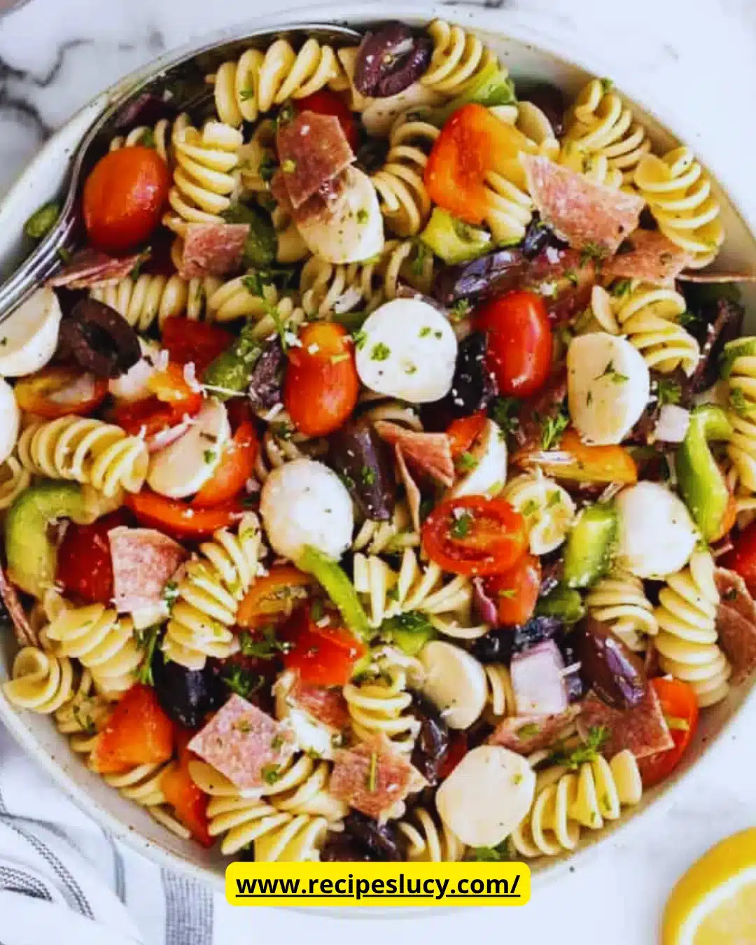 Colorful Italian pasta salad with vegetables and dressing in a bowl