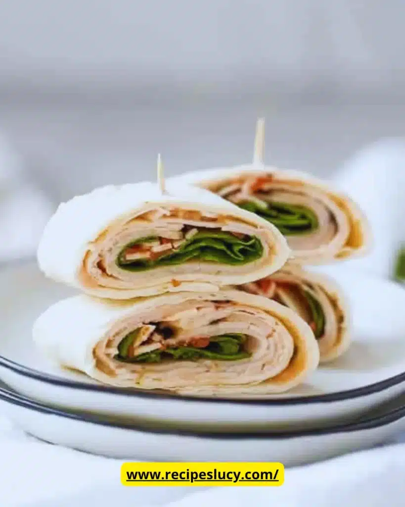 Plate of turkey pinwheels with fresh vegetables and tortillas