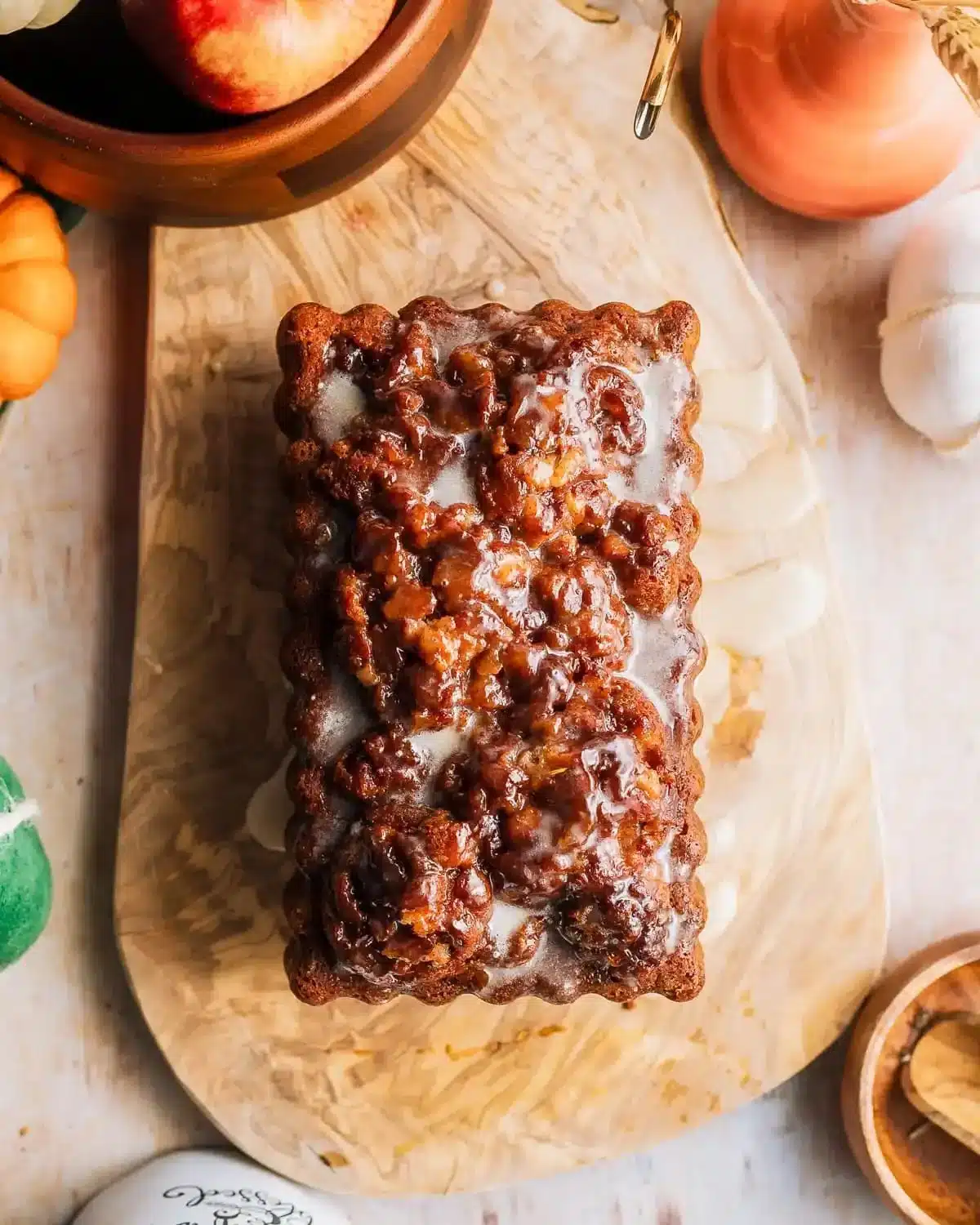Amish apple fritter bread topped with glaze and fresh apple slices