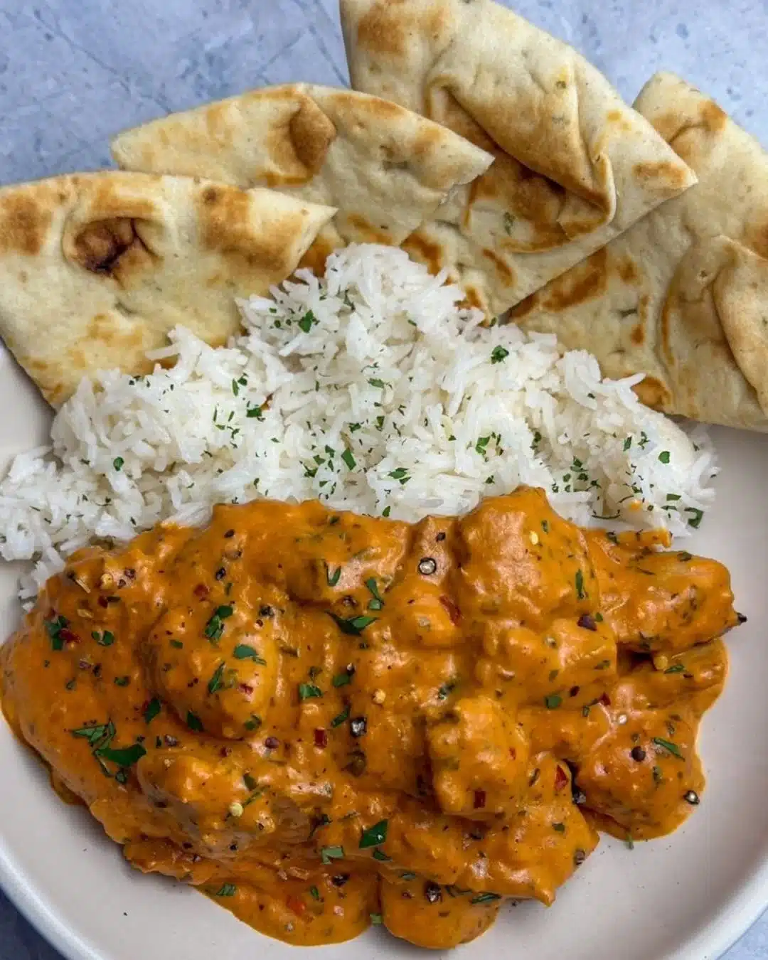Delicious easy homemade butter chicken garnished with fresh cilantro
