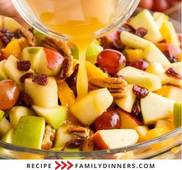 Apple fruit salad with warm fall spice dressing in a bowl.