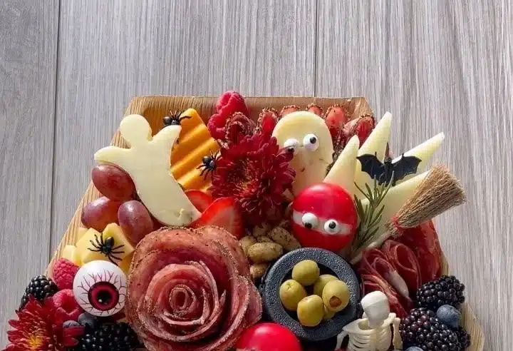 Spooky Halloween charcuterie board displayed on a coffin-shaped platter