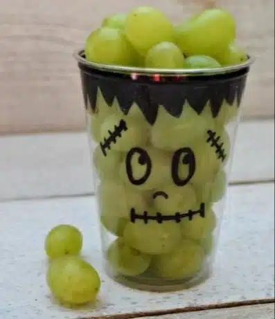 Colorful healthy Halloween snacks featuring fruits and veggies for kids