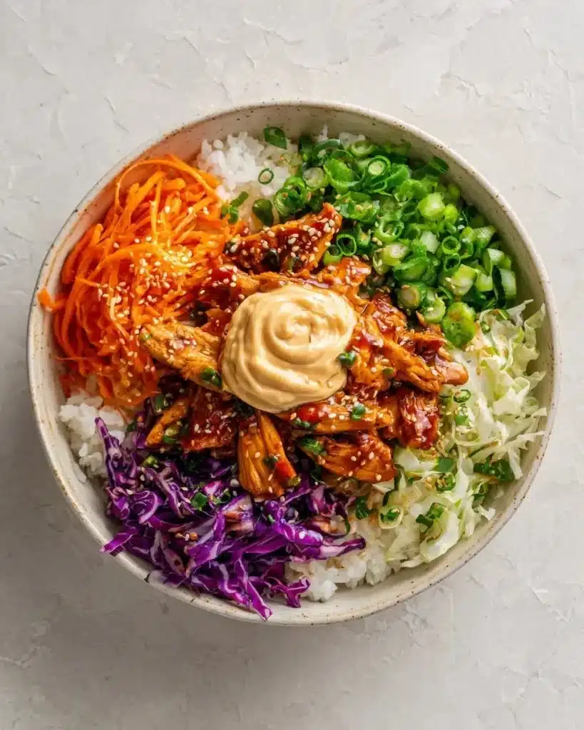 Korean BBQ Chicken Bowl with Gochujang Cream Sauce garnished with vegetables