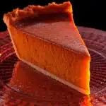 Homemade pumpkin pie with a golden crust and whipped cream topping