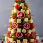 Beautiful Christmas charcuterie board featuring cheeses, meats, and festive decor.