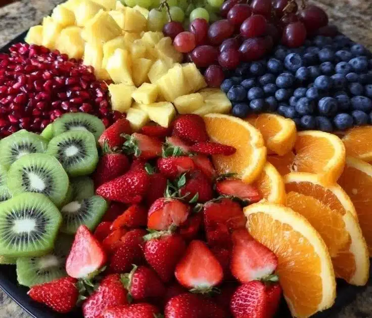 Colorful Christmas fruit tray featuring seasonal fruits for holiday celebrations