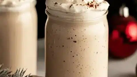 Creamy Bourbon Eggnog garnished with nutmeg in a festive glass