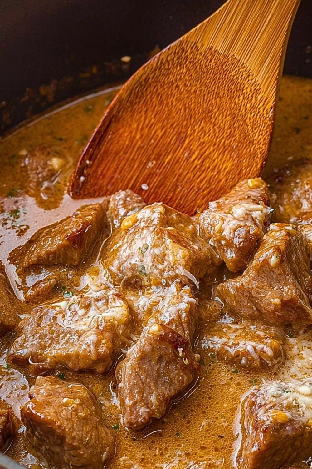 Crockpot Garlic Parmesan Steak Bites served in a dish with herbs
