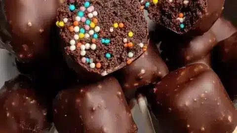 Delicious brownie pops coated in chocolate and sprinkles on a stick.
