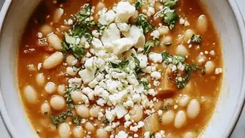 Bowl of delicious Greek White Bean Soup (Fasolada) garnished with parsley.