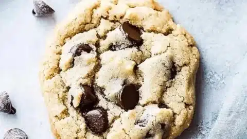 Freshly baked gluten free chocolate chip cookies on a cooling rack
