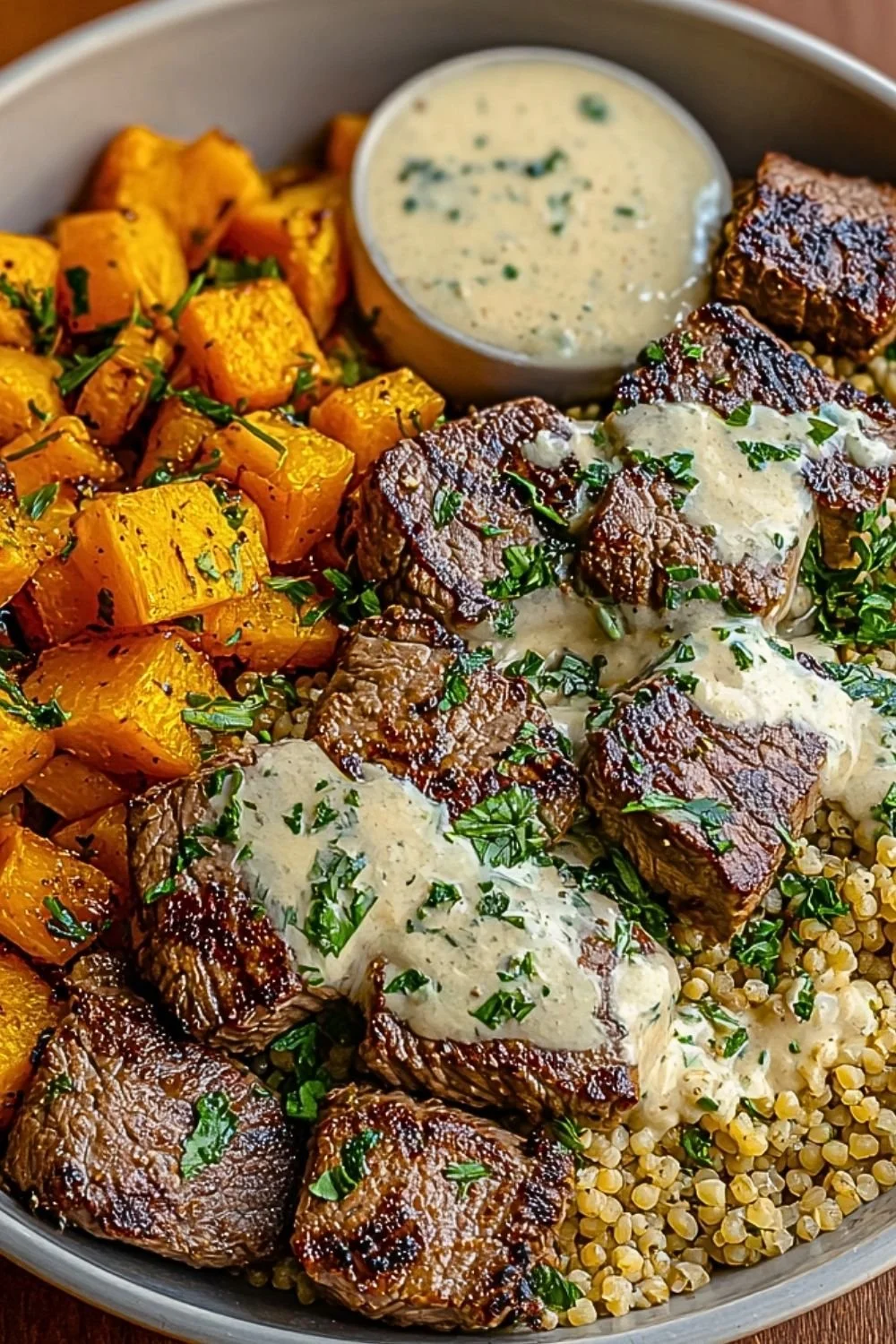 Delicious butternut squash and garlic herb steak bowls served in a rustic setting