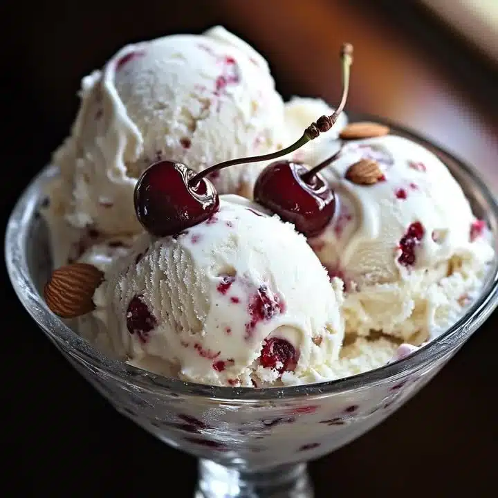 Delicious scoop of almond cherry ice cream in a cone