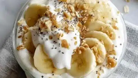 Delicious Banana Cream Pie Overnight Oats topped with banana slices and whipped cream