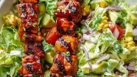 BBQ Chicken Skewer Salad with creamy avocado dressing on a plate