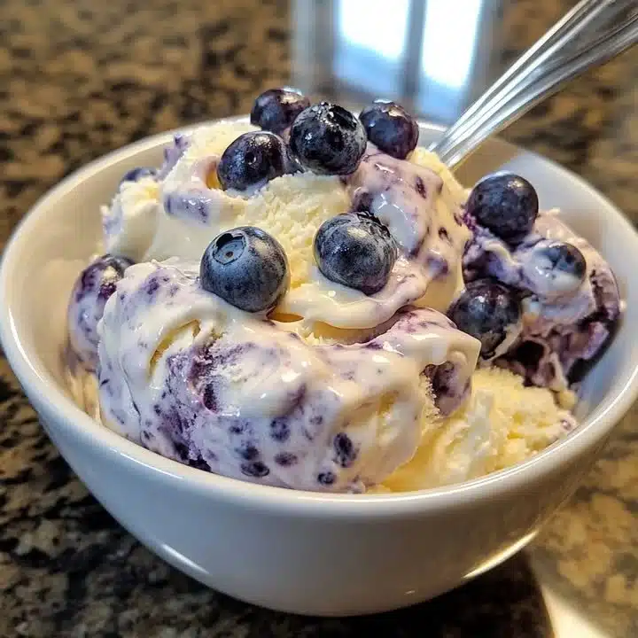 Delicious blueberry cheesecake ice cream topped with fresh blueberries