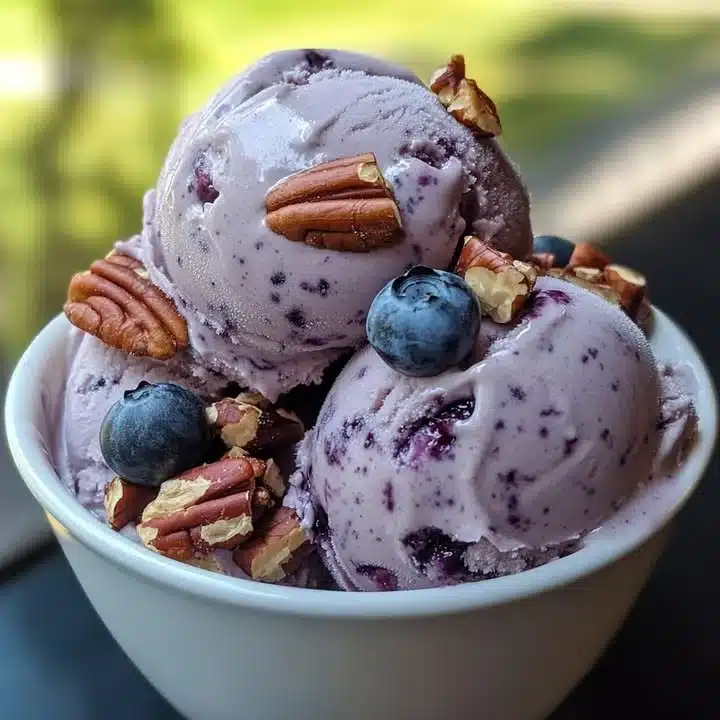 Delicious blueberry pecan ice cream served in a bowl with fresh berries