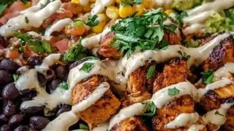 Delicious Chipotle Chicken Bowl with black beans, corn, and creamy sauce