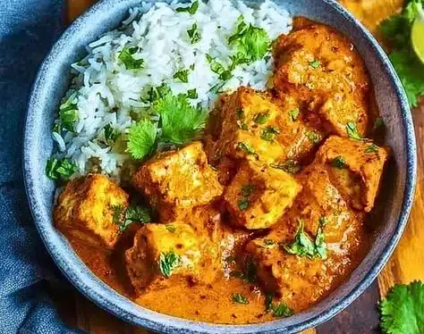 Creamy Cottage Cheese Tikka Curry served with rice and herbs