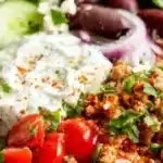 Delicious Greek Turkey Rice Bowls garnished with fresh vegetables and herbs.