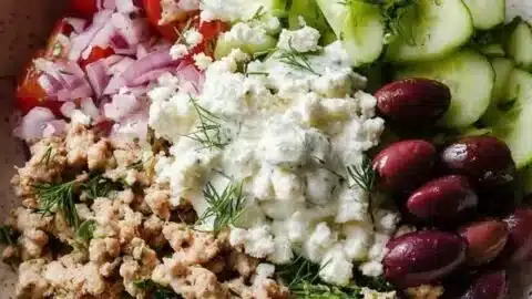 Healthy Greek ground chicken bowls with fresh vegetables and herbs