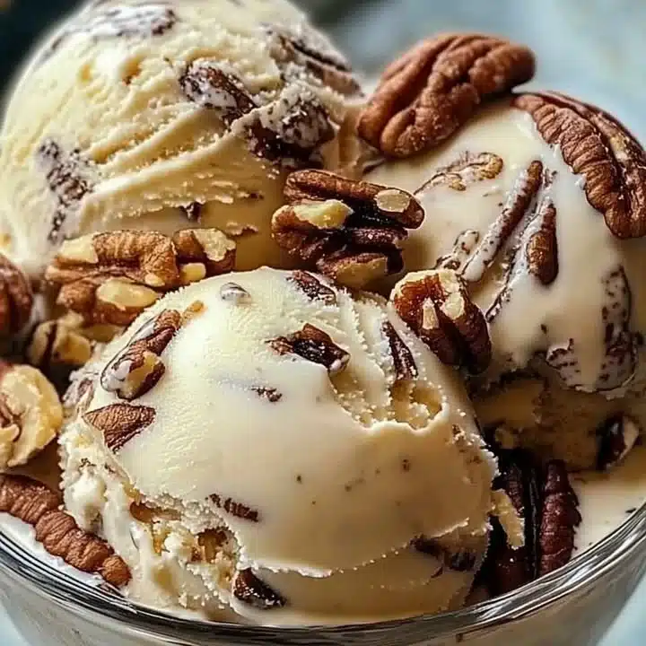 Delicious homemade butter pecan ice cream in a bowl topped with pecans