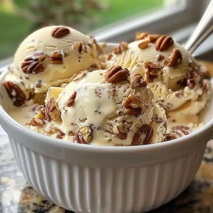 Delicious homemade butter pecan ice cream in a bowl topped with pecans