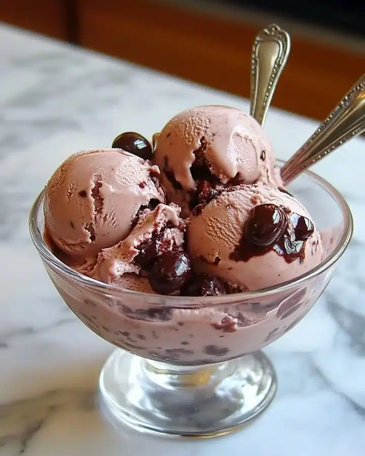Delicious bowl of homemade cherry ice cream topped with fresh cherries