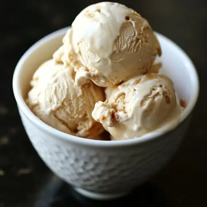 Creamy homemade peanut butter ice cream in a bowl with a spoon