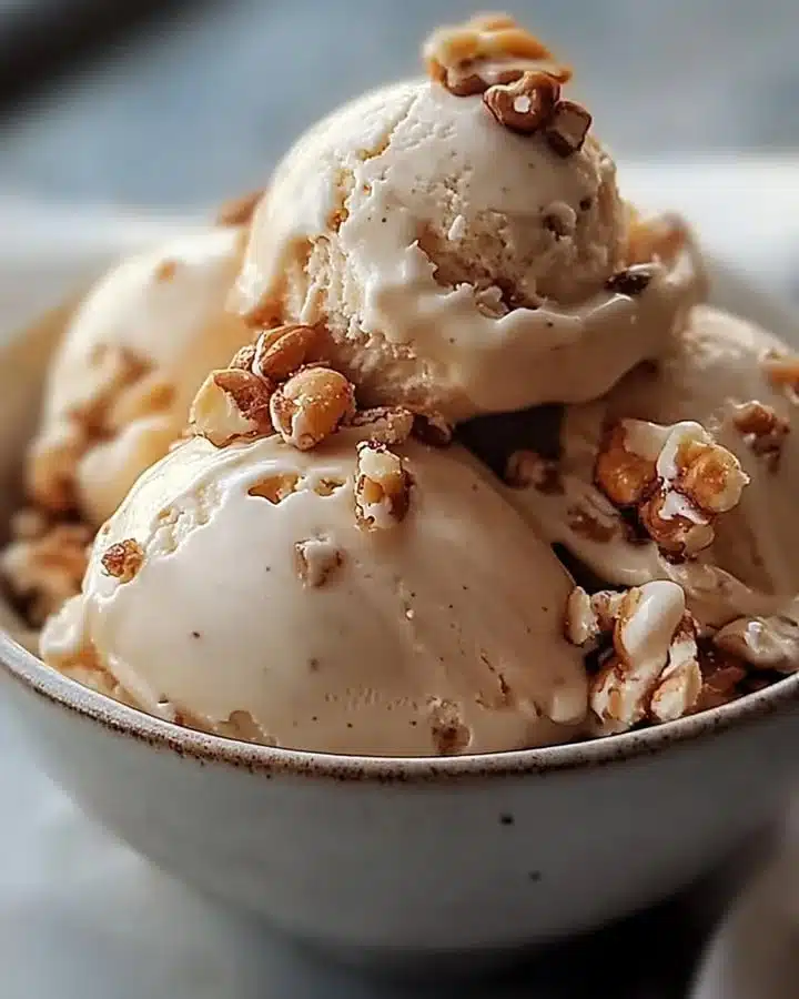 Creamy Maple Walnut Ice Cream topped with crunchy walnuts in a bowl