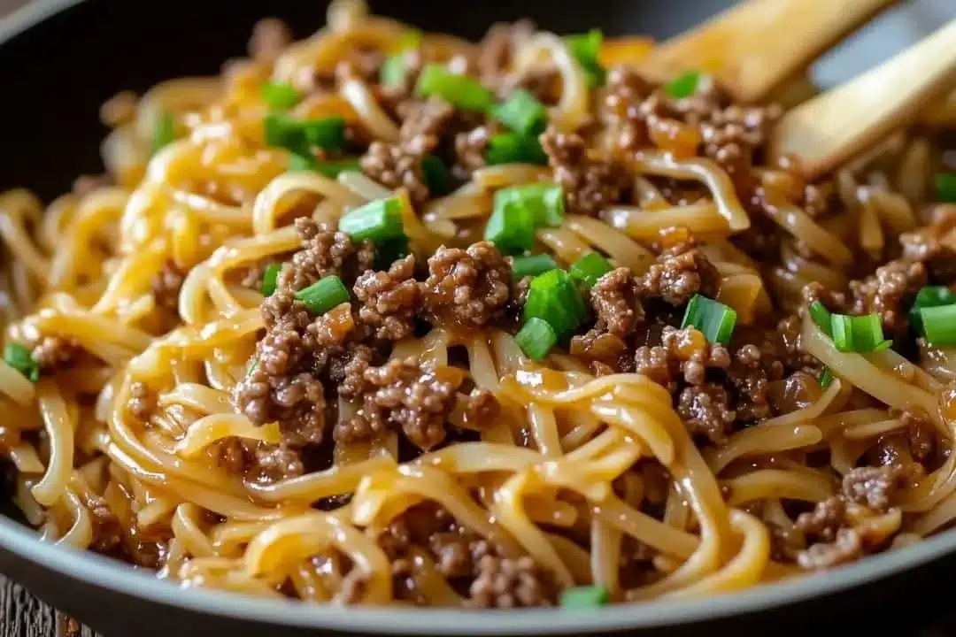 Plate of Mongolian Ground Beef Noodles garnished with green onions