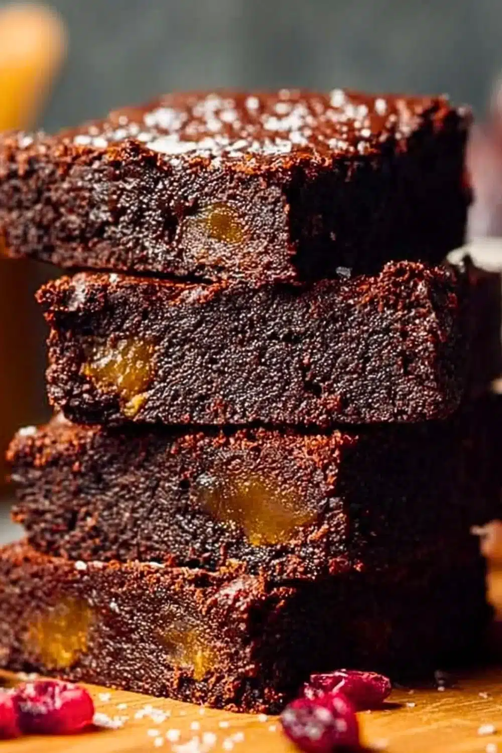 No bake vegan date brownies topped with chocolate and nuts.