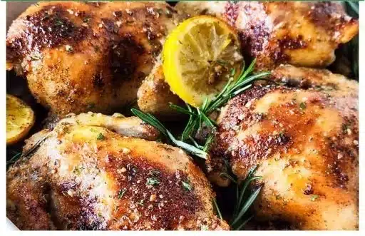 Oven roasted lemon garlic and parmesan cornish hens garnished with herbs