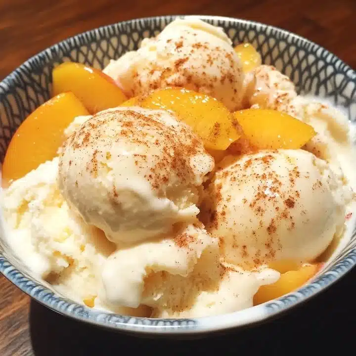 Homemade Peach Yogurt Ice Cream with a sprinkle of cinnamon in a bowl