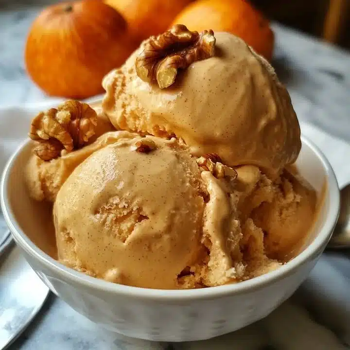 Delicious persimmon walnut ice cream served in a bowl with toppings.