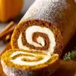 Delicious pumpkin roll dessert with cream cheese filling on a plate