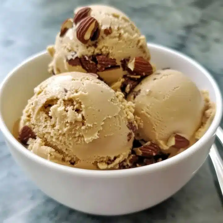 Delicious bowl of salted almond ice cream topped with almonds.