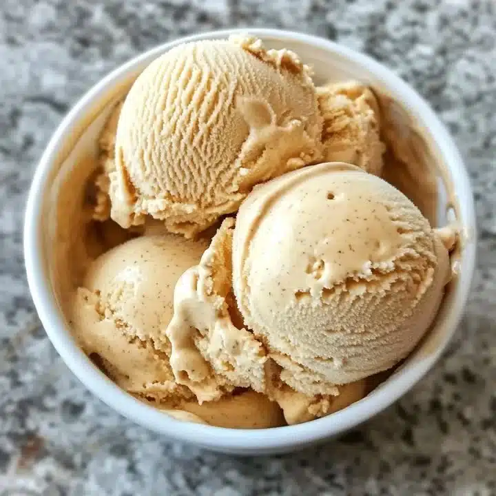Delicious bowl of salted caramel ice cream topped with caramel drizzle and sea salt flakes