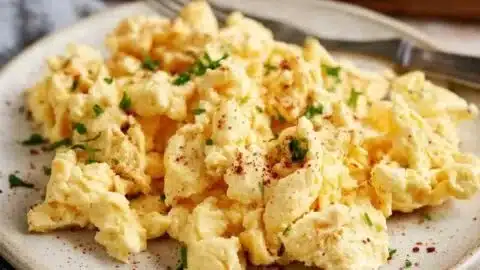 Delicious scrambled eggs with cottage cheese served on a plate