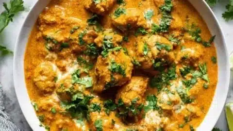 Slow cooker chicken korma with spices and herbs in a bowl
