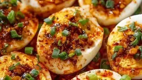 Spicy chili garlic deviled eggs garnished with chili flakes and garlic