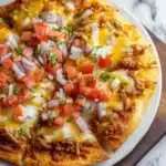 Taco Bell Mexican Pizza with toppings on a wooden table