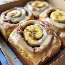 Delicious banana bread cinnamon rolls with a sprinkle of cinnamon on top.