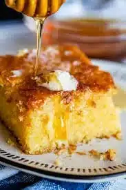 Delicious and fluffy homemade cornbread served warm on a plate.