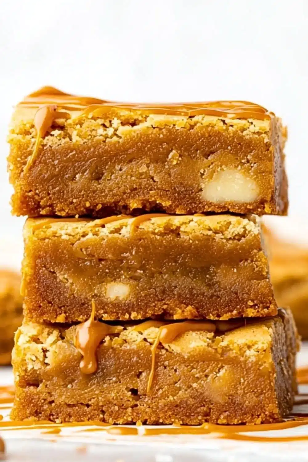 Delicious Biscoff Blondies topped with cookie crumbles.