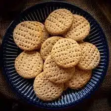 A variety of freshly baked biscuits on a rustic wooden table.